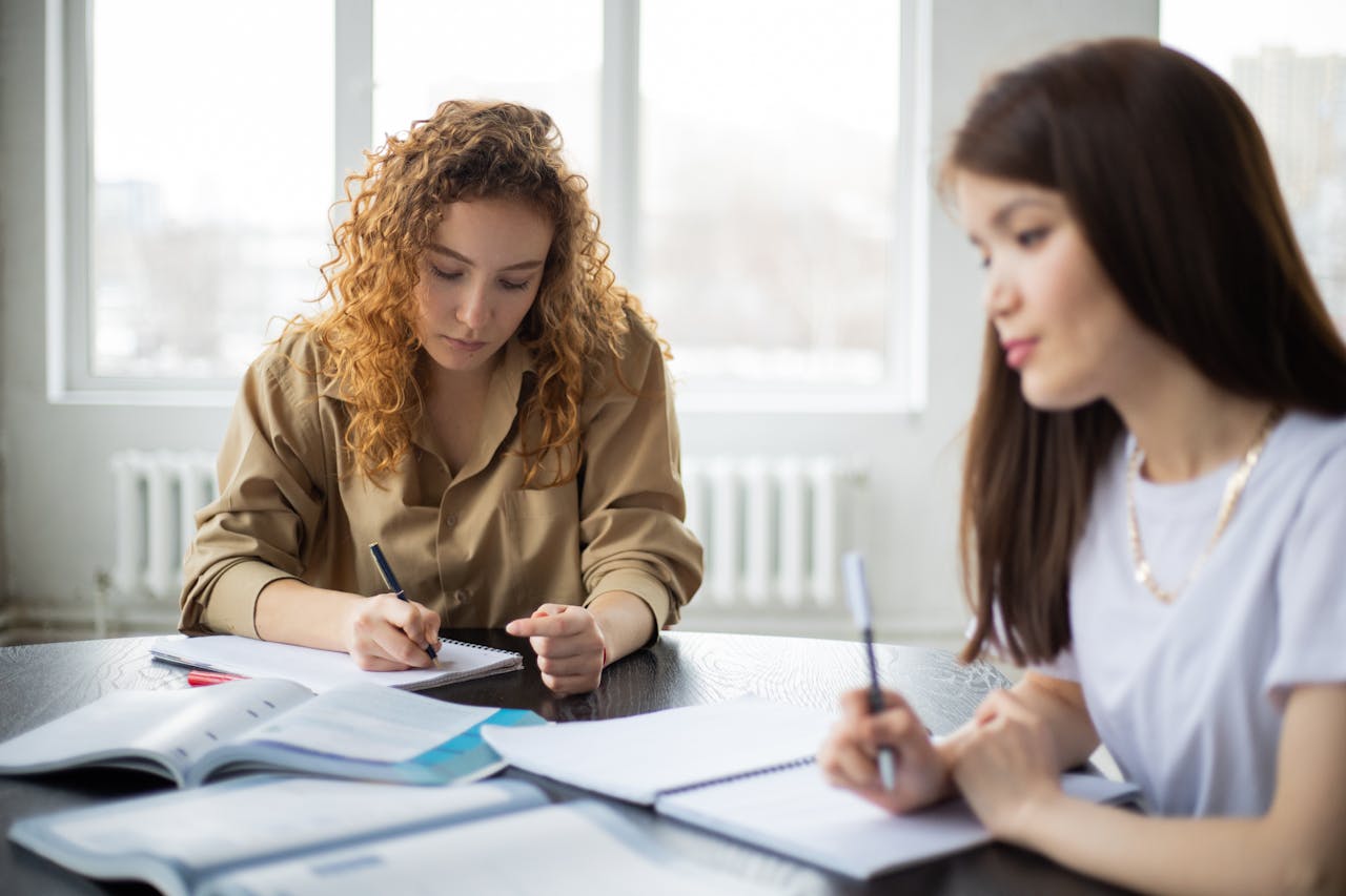 Mastering the First Impression: Your intriguing post title goes here Young women collaborating on a study project in a bright room.